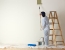 man-painting-wall-with-ladders600x600